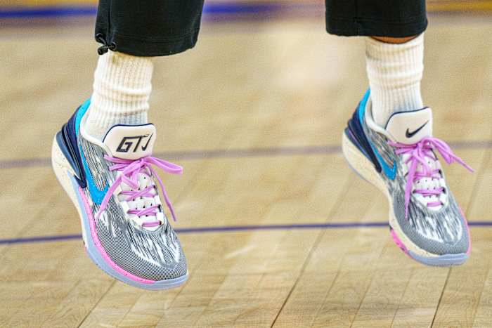 View of Jordan Poole's grey and pink Nike shoes.
